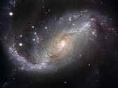 Obraz przedstawiający galaktykę NGC 1672 i gwiazdy we wszechświecie. (Źródło zdjęcia: WikiImages - Pixabay)