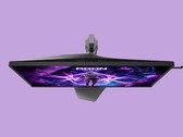 Zdjęcie przedstawia monitor do gier AOC AG276UZ na fioletowym tle. Monitor ten charakteryzuje się bardzo „gierkowym” wyglądem, uzupełnionym o podświetlenie RGB z tyłu urządzenia.