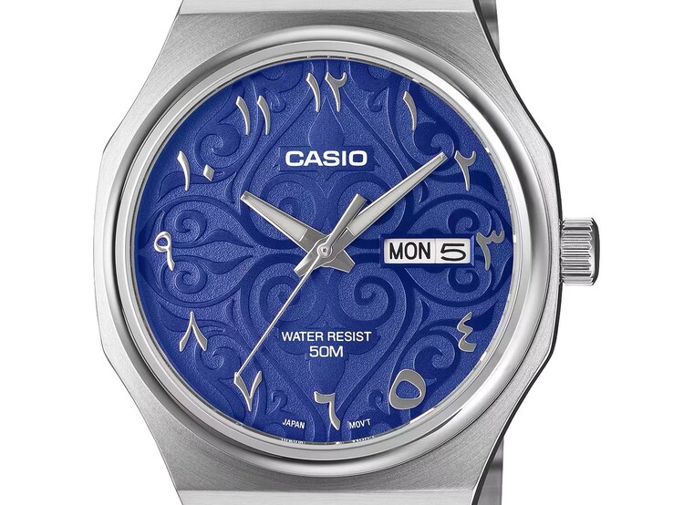 Zbliżenie na model Casio MTP-E735AR-2A2V przedstawiające jego tarczę w żywym niebieskim kolorze z arabeskowym wzorem, nakładane cyfry arabskie w stylu wschodnim, fasetowane srebrne wskazówki w kształcie miecza oraz wskaźnik dnia tygodnia i daty na godzinie 3.