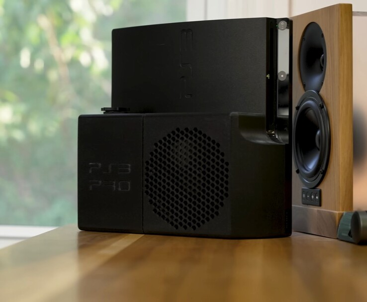 Chłodzona wodą konsola PlayStation 3 z czarną, wydrukowaną w 3D tylną obudową "PS3 Pro" obok drewnianego głośnika. (Źródło zdjęcia: Zac Builds via YouTube)