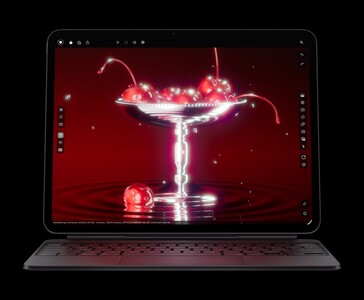 Apple iPad Pro M5 z klawiaturą Magic Keyboard wyświetlający render 3D wiśni, prezentujący wyświetlacz Ultra Retina XDR OLED i układ graficzny M5 (źródło obrazu: Apple)