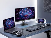 Monitor gamingowy Asus XG27UCMG wraz z różnymi urządzeniami elektronicznymi marki Asus