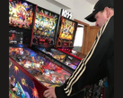 Nowozelandzki kolekcjoner automatów do pinballa Kim Michael Dozier gra na automacie do pinballa Iron Maiden w Kimzone