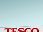 Zewnętrzne oznakowanie Tesco sfotografowane na tle czystego nieba (źródło zdjęcia: Simone Hutsch via Unsplash)