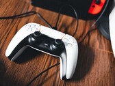 Zdjęcie kontrolera PS5 obok konsoli Nintendo Switch