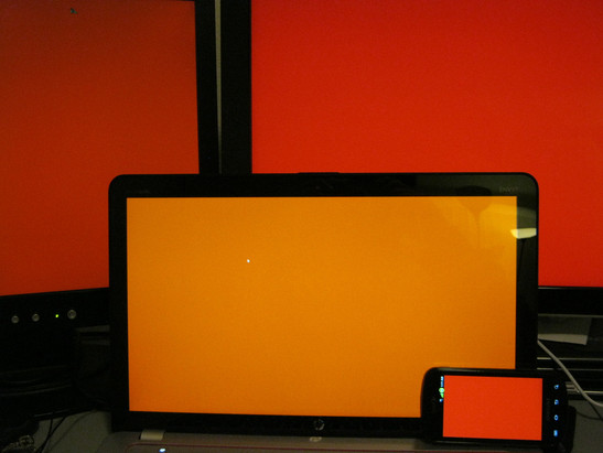 kolor czerwony na ekranach monitorów Acer AL1912 (w głębi z lewej), HP w2408h (w głębi z prawej), laptopa HP Envy 15 z matrycą Radiance Full HD (w środku) oraz smartfonu Samsung Galaxy S (w prawym dolnym rogu)