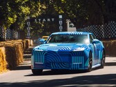 Jaguar Type 01 EV w kamuflażu „Blue Exuberant Modernism” pędzący obok linii startowej podczas wyścigu Goodwood Hill Climb